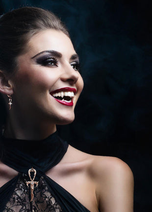 Gertraudt is wearing 3rd Generation Legacy Ankh with Opal and Earrings, both in Rose Gold over Sterling Silver. Her fangs are handmade Beast Classics by Father Sebastiaan available only by appointment at Sabretooth Fangs. Makeup by JoHanna Moresco.
