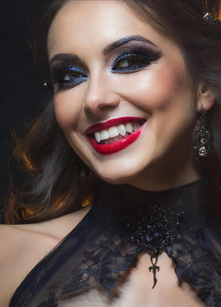 Ester is wearing the 2nd Generation Small Silver Ankh in "Black Metal" rated Sterling Silver . She wears Lilith Laterals  3D fangs by Sabretooth Fangs. Makeup by JoHanna Moresco.